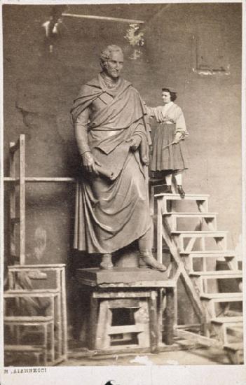 Harriet Hosmer on ladder with her sculpture of Thomas Hart Benton c. 1860