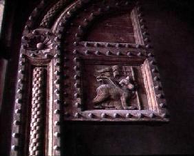 Carved door panel from the Duomoshowing a bear cub carrying a flag 14th centu