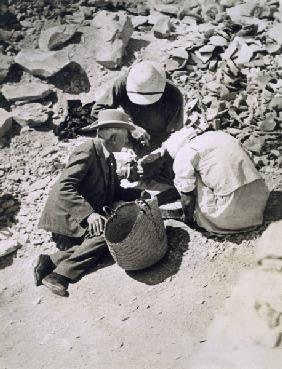 Sir Charles Cust (in soft hat) the King''s Equerry, with Mr Callender sifting the dust from the floo