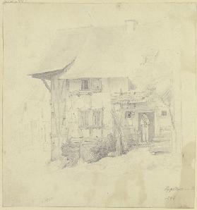 Bauernhaus in Eppstein, unter der Haustür steht ein Mann mit einem Kind auf dem Arm