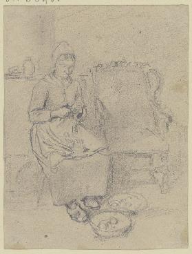 Eine alte Bäuerin sitzt neben einem Sessel und schält Kartoffeln