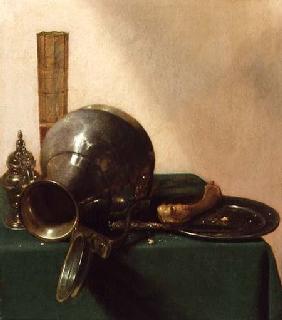 A still life of an overturned jug, a glass of wine, a bone on a plate, all on a green tablecloth c.1632-37