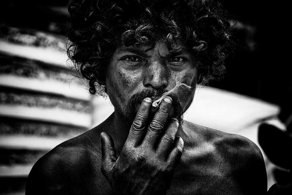 Ein Obdachloser,der in den Straßen von Delhi raucht. von Joxe Inazio Kuesta Garmendia