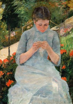 Junge strickende Frau im Garten um 1880/18