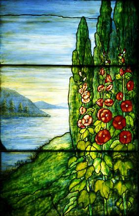 A Mountainous Lake Scene With Red Blossoming Hollyhocks And Arbor Vitae Painted And Leaded Glass Lan