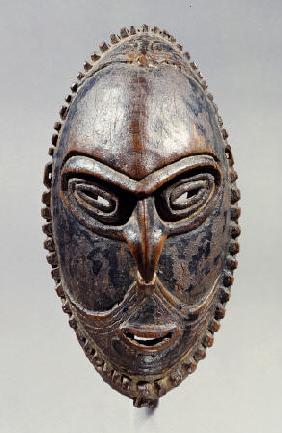 A New Guinea Mask Of Oval Form With Pierced Eyes, Mouth And Septum