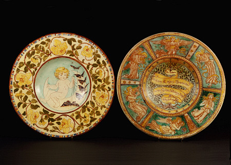 Two Della Robbia Wall Chargers, One Depicting A Putto Riding A Crescent Moon, The Other Designed By von 