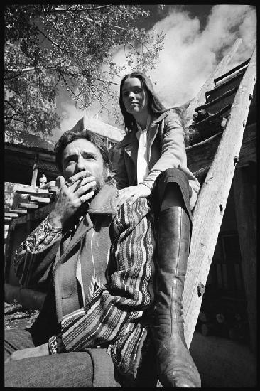 Dennis Hopper and wife Michelle Phillips on a ladder in New Mexico 1970