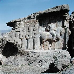 Rock relief depicting Shapur I (AD 241-72) and his family wearing heraldic emblems on their hats, wi